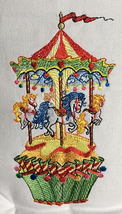 Machine embroidered Carousel Cupcake design.